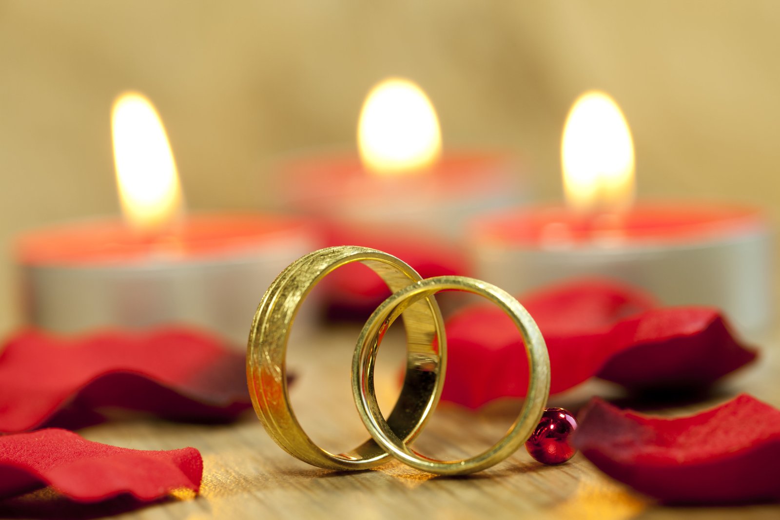 Closeup Shot Wedding Rings With Background Beautiful Red Roses Candles Table